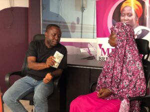 Executive Director, CCF and MBCF, Ibrahim Oppong Kwarteng handing a cash amount of money to breast cancer patient, Abiba Abu