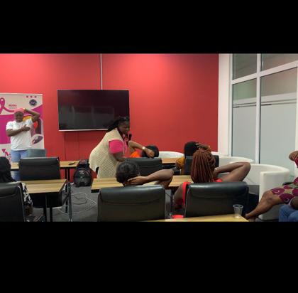 MBCF staff demonstrates self-breast examination during sensitization exercise at the Accra Digital Centre